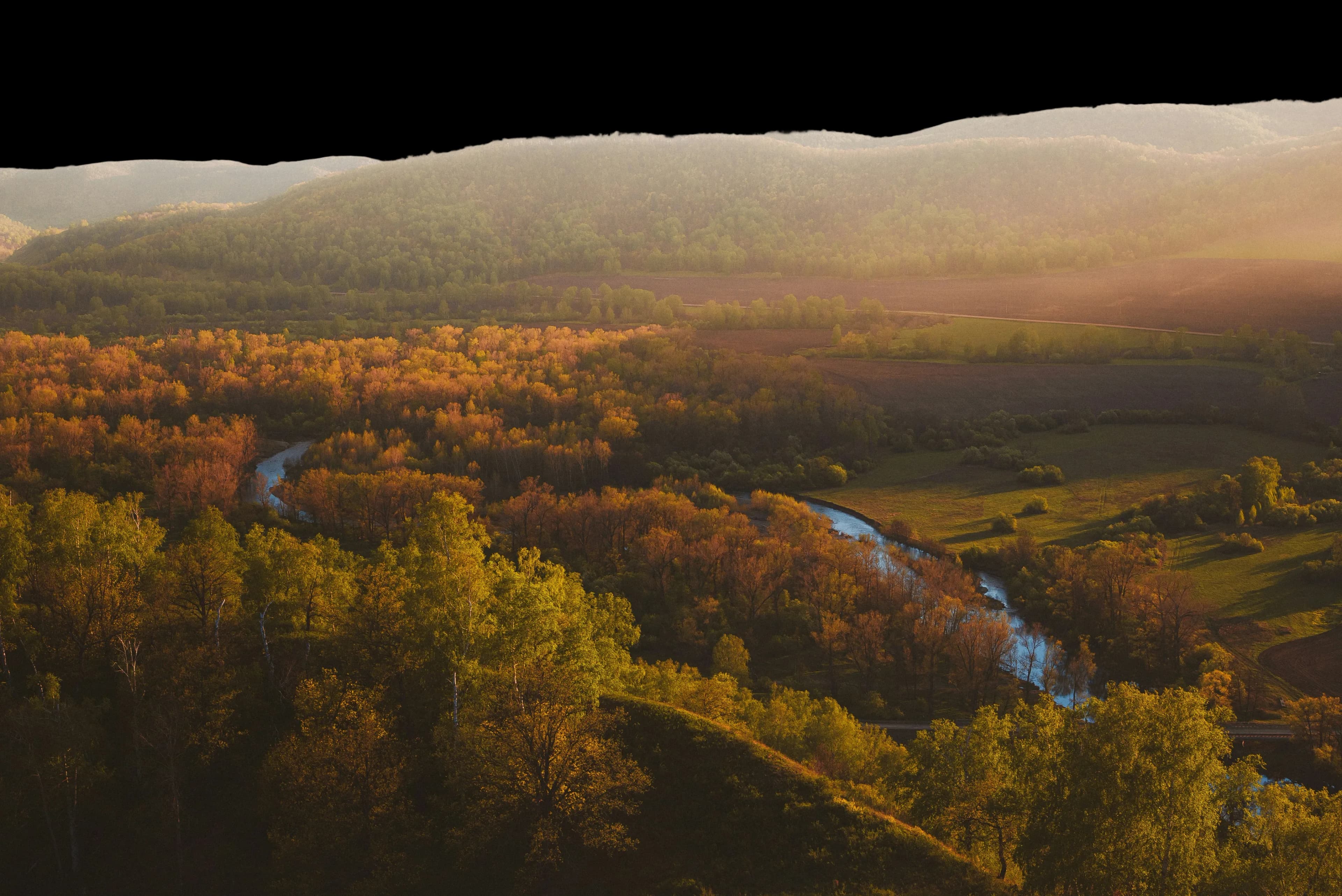Distant Russian mountains and forest at sunset